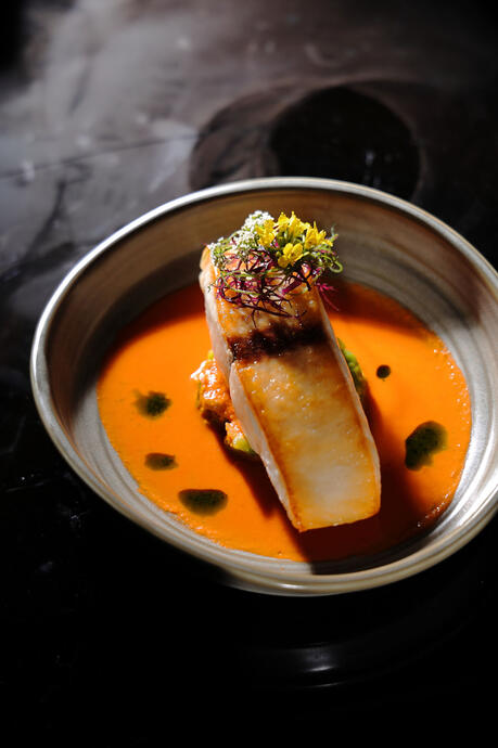 Flaky cod resting in velvety tomato sauce